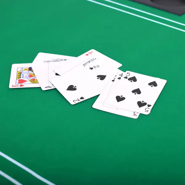A professional croupier managing an elegant roulette table with gold trim — the premium atmosphere at TKHOT.